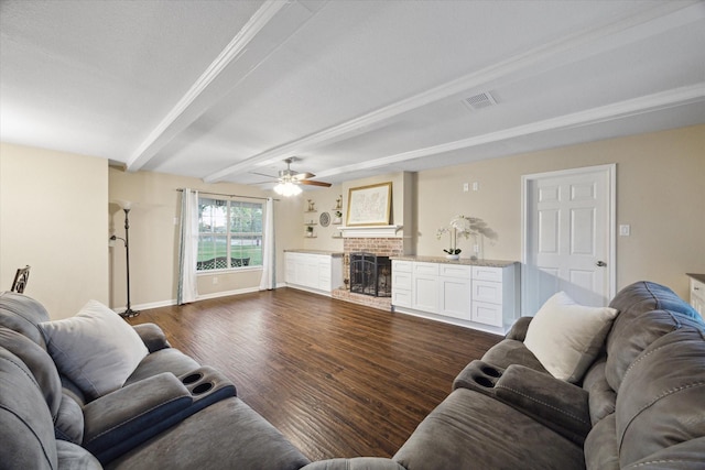 101 Royal Ct, Friendswood, TX 77546 - living room with beamed ceiling, ceiling fan, a fireplace, dark wood-type flooring, and baseboards