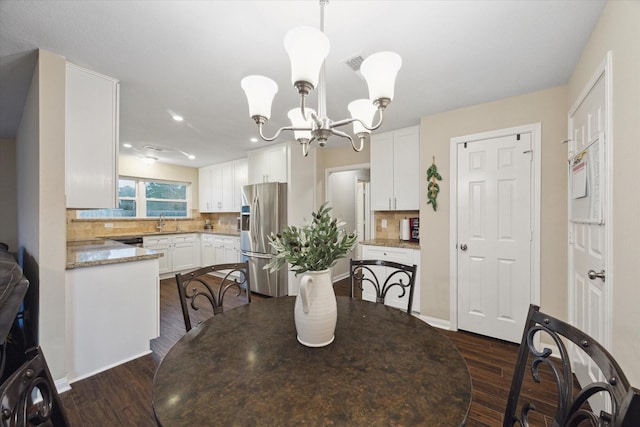 101 Royal Ct, Friendswood, TX 77546 - dining area featuring a chandelier, dark wood-style floors, recessed lighting, and baseboards