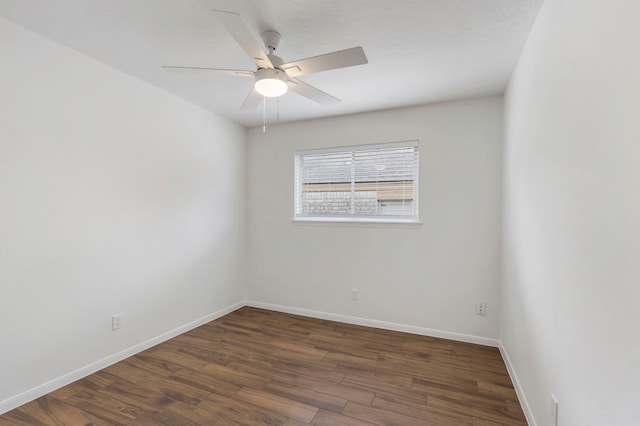 empty room featuring ceiling fan, baseboards, and wood finished floors