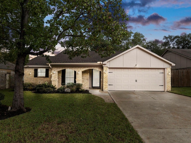 single story home featuring a garage, driveway, a front yard, and a shingled roof
