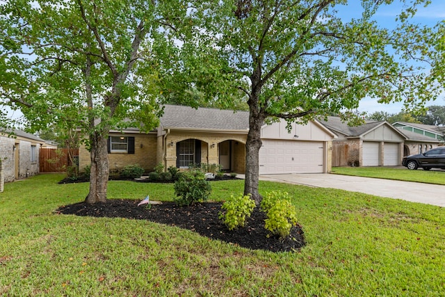 single story home featuring brick siding, an attached garage, fence, a front yard, and driveway