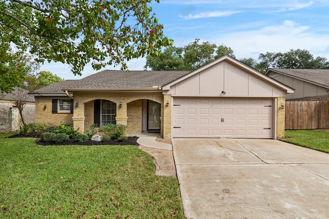 single story home with driveway, fence, an attached garage, a front yard, and brick siding