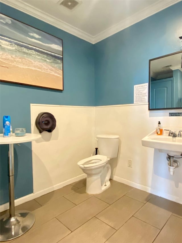 2425 Strand St, Galveston, TX 77550 - half bathroom with ornamental molding and tile patterned flooring