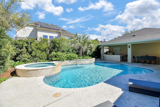view of swimming pool with a pool with connected hot tub, outdoor dry bar, and a patio area