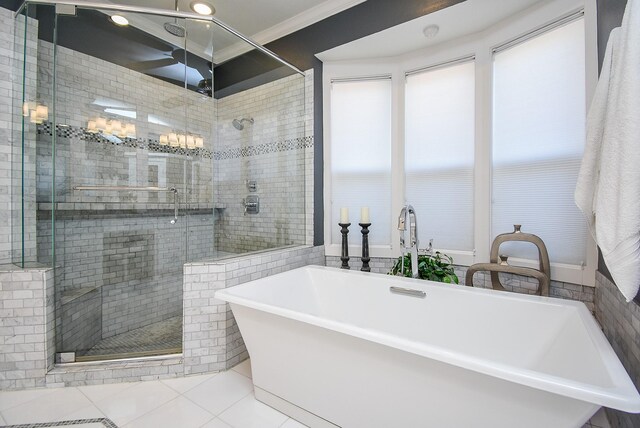 bathroom featuring tile patterned floors, a soaking tub, a stall shower, and ornamental molding