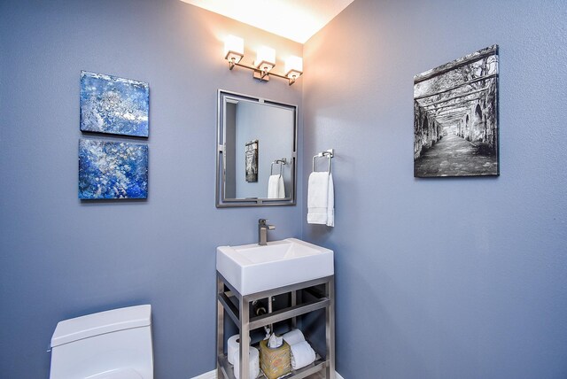 bathroom featuring toilet and vanity