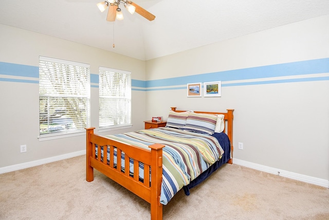 bedroom featuring baseboards, carpet floors, lofted ceiling, and a ceiling fan