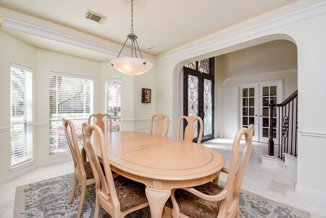 dining room with french doors, arched walkways, visible vents, and a healthy amount of sunlight