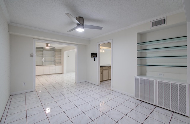 unfurnished room featuring a textured ceiling, crown molding, visible vents, and ceiling fan