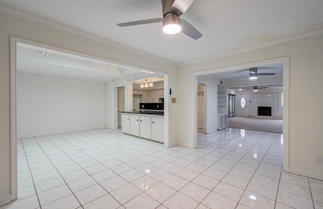 kitchen featuring dark countertops, ceiling fan, and ornamental molding