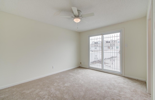 spare room with carpet flooring, a textured ceiling, and ceiling fan