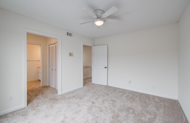 unfurnished bedroom with visible vents, baseboards, carpet flooring, a closet, and a ceiling fan