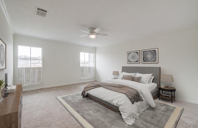 bedroom with visible vents, ornamental molding, carpet flooring, baseboards, and ceiling fan