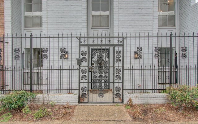 view of exterior entry featuring fence
