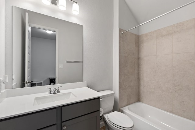 full bathroom with vanity, toilet, a textured wall, and shower / bathtub combination