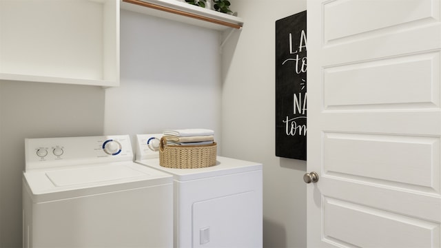 clothes washing area with washing machine and clothes dryer and laundry area