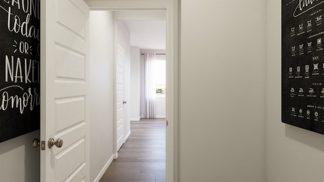 corridor with baseboards and dark wood-style flooring