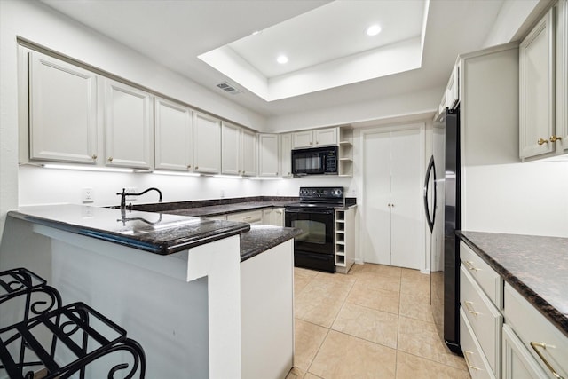 259 Litchfield Ln Unit 66, Houston, TX 77024 - kitchen featuring black appliances, open shelves, a peninsula, a sink, and a breakfast bar area