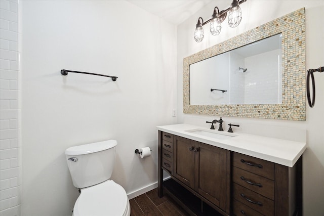 259 Litchfield Ln Unit 66, Houston, TX 77024 - bathroom with toilet, wood finished floors, vanity, and tiled shower