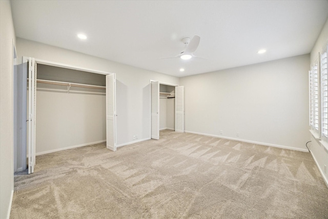 259 Litchfield Ln Unit 66, Houston, TX 77024 - unfurnished bedroom featuring multiple closets, carpet floors, recessed lighting, baseboards, and a ceiling fan