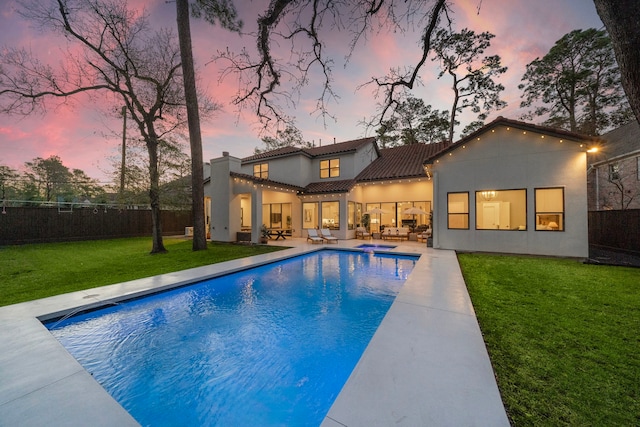rear view of property with outdoor lounge area, stucco siding, a tiled roof, a patio area, and a chimney