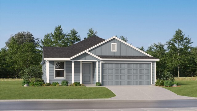 309 Nicholas Rd, Wharton, TX 77488 - view of front of house featuring an attached garage, concrete driveway, a front yard, and board and batten siding