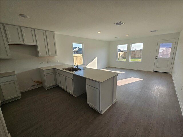 309 Nicholas Rd, Wharton, TX 77488 - kitchen with a sink, dark wood-style floors, a peninsula, baseboards, and recessed lighting