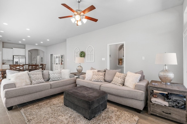 156 Buckeye Dr, Montgomery, TX 77316 - living room featuring light wood-style floors, arched walkways, ceiling fan, and recessed lighting