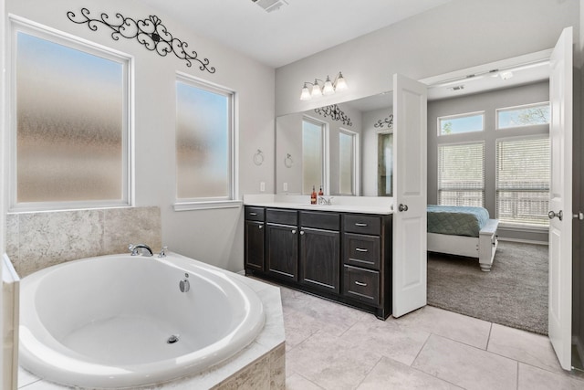 156 Buckeye Dr, Montgomery, TX 77316 - ensuite bathroom with vanity, tile patterned flooring, visible vents, ensuite bathroom, and a bath