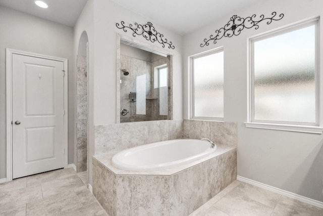 156 Buckeye Dr, Montgomery, TX 77316 - bathroom featuring a garden tub, baseboards, and a tile shower