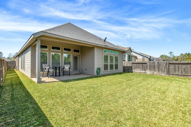 156 Buckeye Dr, Montgomery, TX 77316 - back of property with a lawn, a fenced backyard, a patio area, and a shingled roof