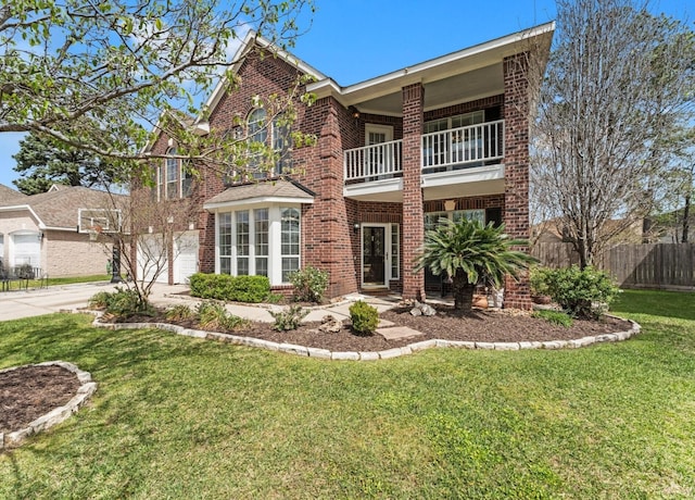 20810 Divellec Ln, Spring, TX 77388 - traditional-style house with a balcony, brick siding, driveway, and a garage