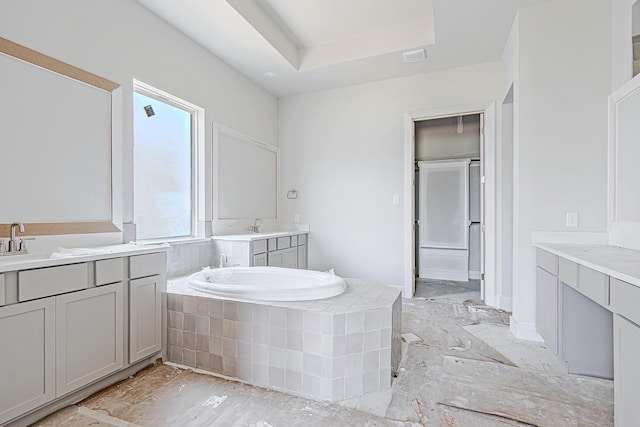 197 Peninsula Point Dr, Montgomery, TX 77356 - bathroom featuring a garden tub, two vanities, and a raised ceiling