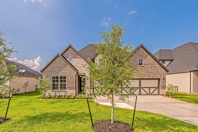197 Peninsula Point Dr, Montgomery, TX 77356 - view of front of house with stone siding, concrete driveway, and a front yard