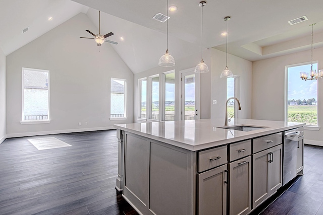197 Peninsula Point Dr, Montgomery, TX 77356 - kitchen featuring gray cabinetry, open floor plan, dark wood finished floors, a center island with sink, and high vaulted ceiling