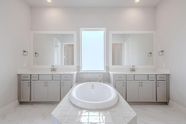 197 Peninsula Point Dr, Montgomery, TX 77356 - bathroom with marble finish flooring, two vanities, a garden tub, and recessed lighting