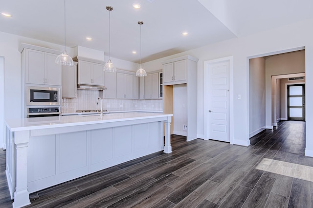 197 Peninsula Point Dr, Montgomery, TX 77356 - kitchen with built in microwave, oven, light countertops, tasteful backsplash, and a large island