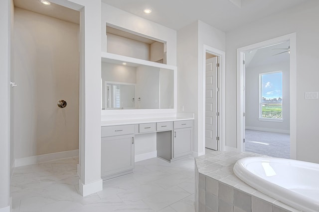 197 Peninsula Point Dr, Montgomery, TX 77356 - bathroom with vanity, a garden tub, marble finish floors, and recessed lighting