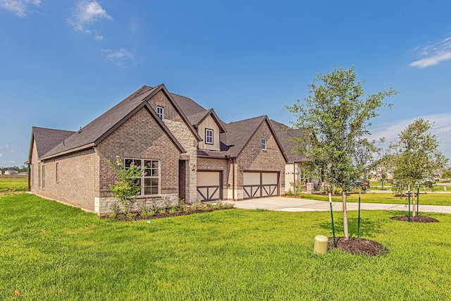 197 Peninsula Point Dr, Montgomery, TX 77356 - view of front facade featuring brick siding, concrete driveway, a front lawn, and stone siding