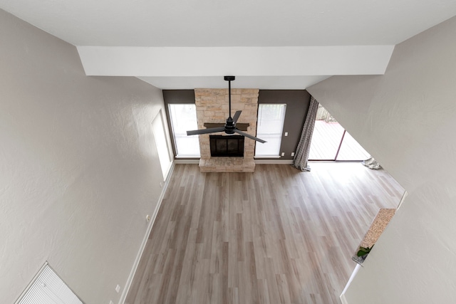 unfurnished living room featuring wood finished floors and baseboards
