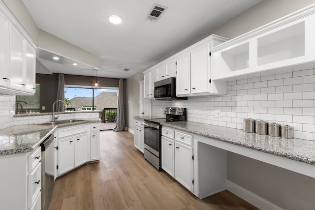 kitchen with visible vents, light wood-style flooring, a sink, open shelves, and appliances with stainless steel finishes