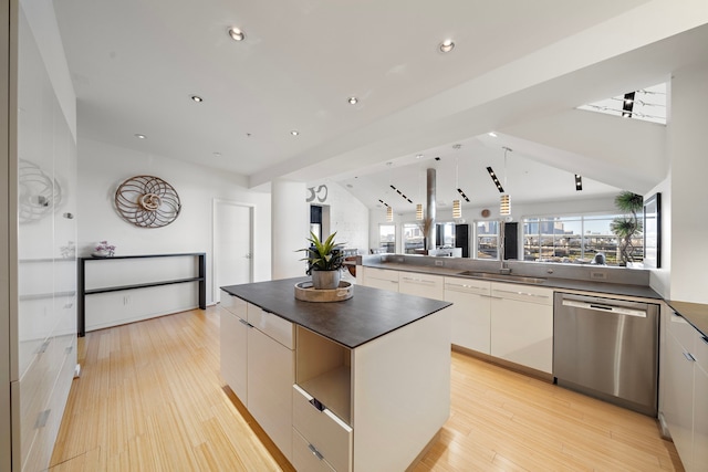 102 Quitman St Unit 405, Houston, TX 77009 - kitchen with modern cabinets, dark countertops, light wood finished floors, and dishwasher