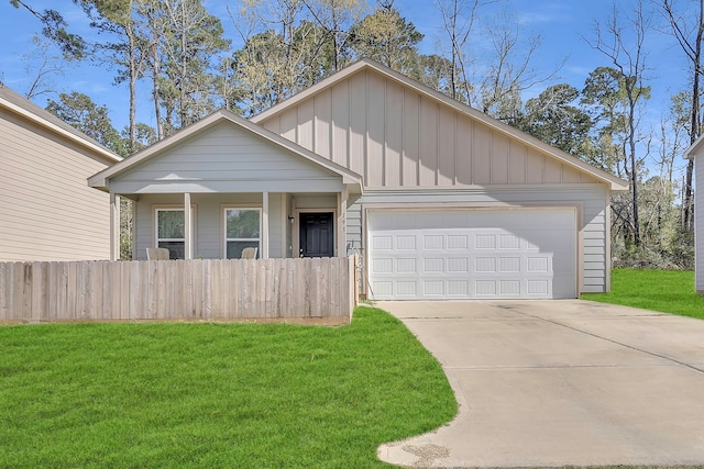 view of front of house featuring board and batten siding, a front lawn, fence, driveway, and an attached garage