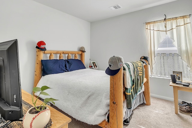 carpeted bedroom with visible vents and baseboards