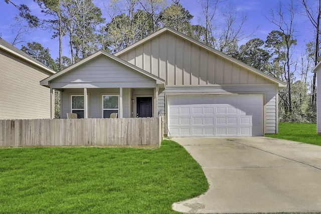 ranch-style home with driveway, a front lawn, an attached garage, and fence