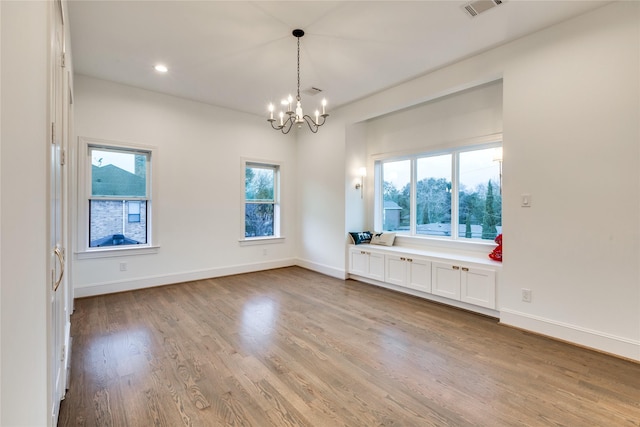 3302 Elmridge St, Houston, TX 77025 - unfurnished room with visible vents, wood finished floors, recessed lighting, baseboards, and a chandelier
