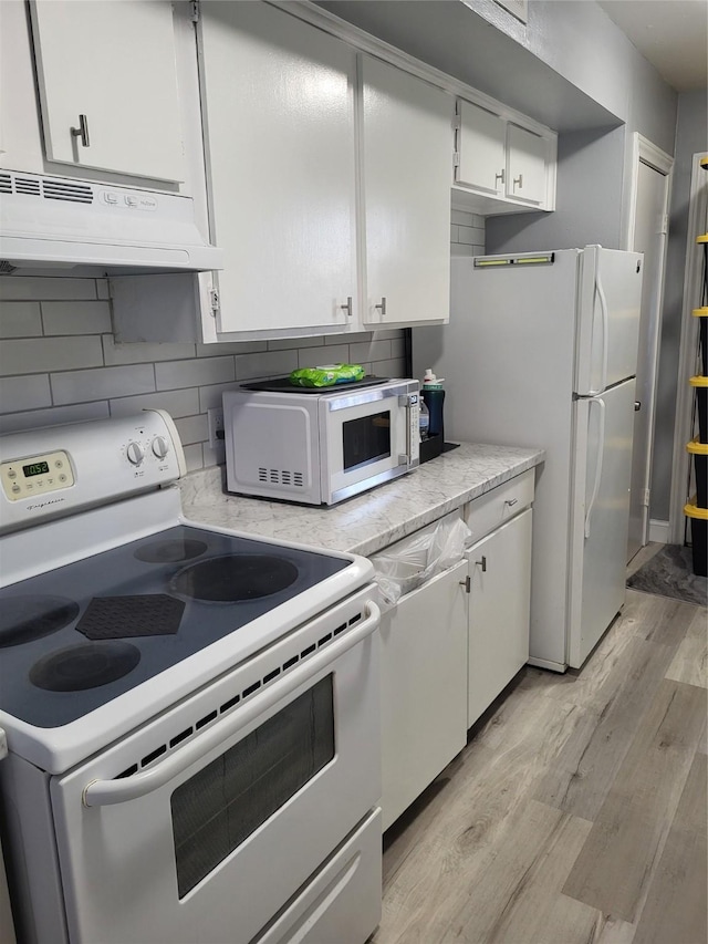 kitchen with range hood, white appliances, white cabinets, light wood finished floors, and light countertops