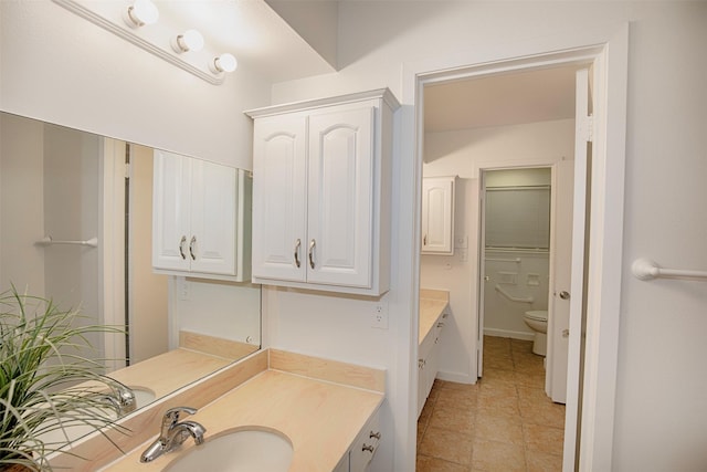 full bath with toilet, vanity, and tile patterned floors