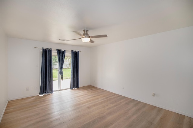 spare room with light wood-style floors, visible vents, baseboards, and ceiling fan