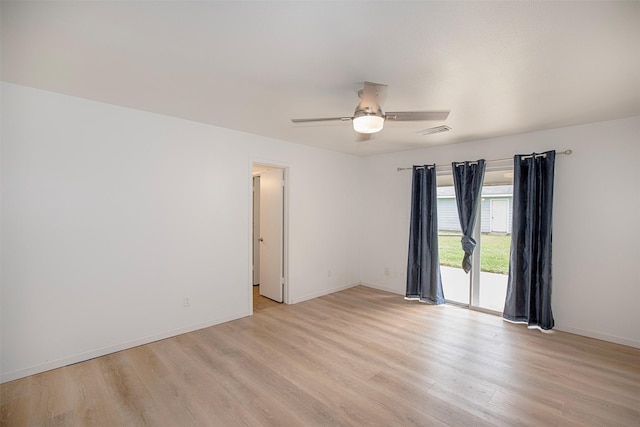 unfurnished room with baseboards, visible vents, light wood-style floors, and ceiling fan